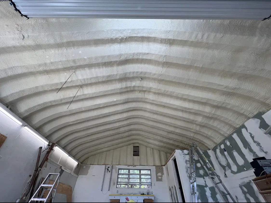 Spray polyurethane foam applied to the underside of a metal roof deck in Lanham